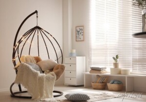 cozy-hanging-chair-with-fairy-lights-in-modern-living-room-interior-design-700-196532622 cozy hanging chair with fairy light in modern living room interior design